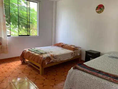 a bedroom with two beds and a window at Viña J Felix in Lunahuaná