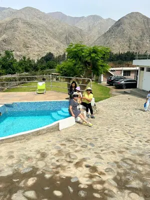 a group of people standing next to a swimming pool at Viña J Felix in Lunahuaná