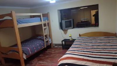 a bedroom with a bunk bed and a television at Roman House 701 in Cusco