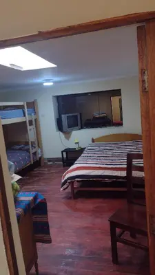 a bedroom with a bed in a room with a bunk bed at Roman House 701 in Cusco