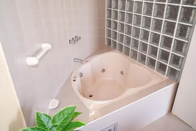 a bathroom with a bath tub in the corner at La Casa Redonda - Supe in Barranca
