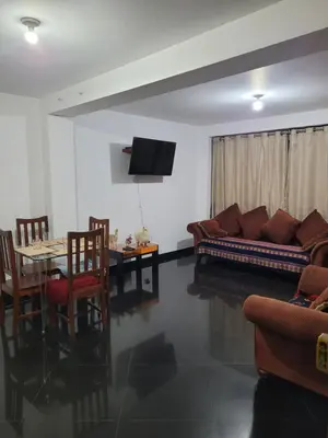 a living room with a couch and a table at Departamento cerca del aeropuerto in Lima