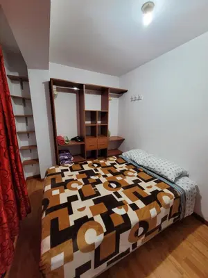 a bedroom with a large bed in a room at Departamento cerca del aeropuerto in Lima
