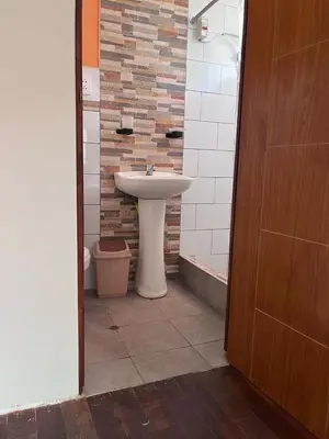 a bathroom with a sink and a toilet at Montañita Lodge in La Merced