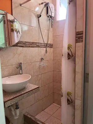 a bathroom with a sink and a shower at Montañita Lodge in La Merced