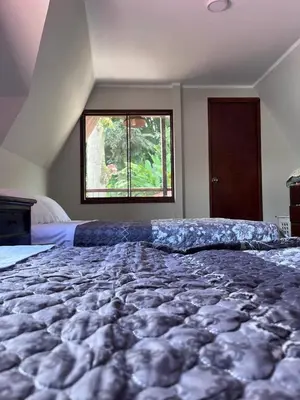 a large bed in a bedroom with a window at Montañita Lodge in La Merced