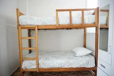 a bunk bed with a pillow on the bottom bunk at Jatun Coya in Huancayo