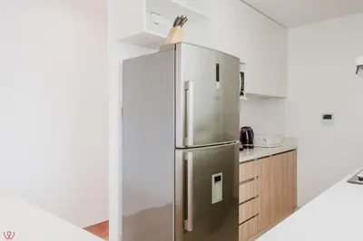 a stainless steel refrigerator in a white kitchen at Charming 3BR in Barranco in Lima