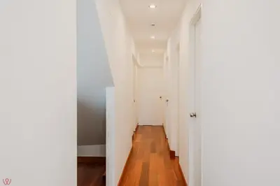 a hallway with white walls and a wooden floor at Charming 3BR in Barranco in Lima