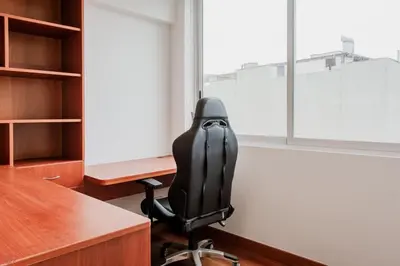 a black chair in an office with a desk and window at Charming 3BR in Barranco in Lima