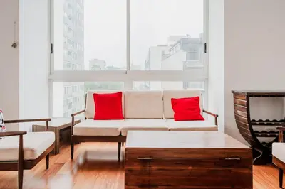 a living room with a couch and red pillows at Charming 3BR in Barranco in Lima