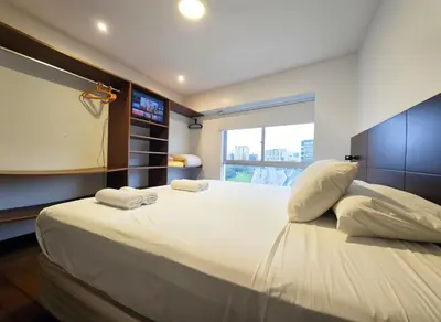 a bedroom with a large bed with two towels on it at E LarcomarZone Sea View All Inclusive 3B 701 in Lima