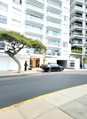 a car parked in front of a large building at E LarcomarZone Sea View All Inclusive 3B 701 in Lima