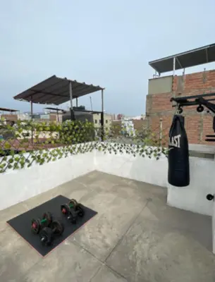 a pair of toy robots sitting on a mat on a rooftop at House in Barranco, Hot Tub & Rooftop Cinema, 11 P in Lima