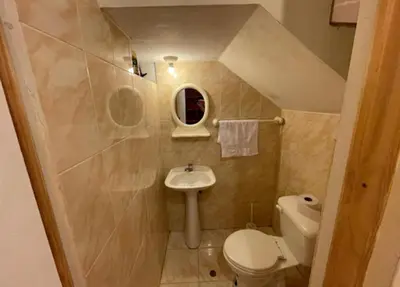 a small bathroom with a sink and a toilet at House in Barranco, Hot Tub & Rooftop Cinema, 11 P in Lima