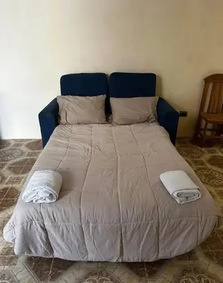 a large bed with two towels on top of it at House in Barranco, Hot Tub & Rooftop Cinema, 11 P in Lima