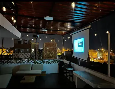 a living room with a large screen in a building at House in Barranco, Hot Tub & Rooftop Cinema, 11 P in Lima
