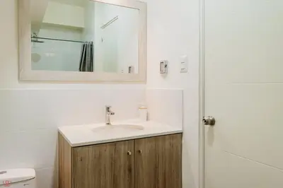 a bathroom with a sink and a mirror and a toilet at Polished 2BR with Balcony in San Isidro in Lima