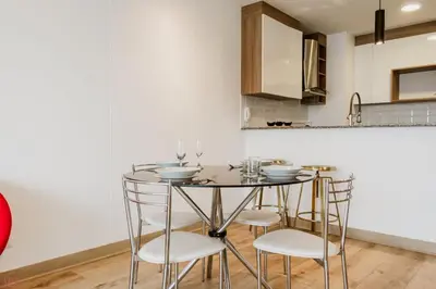 a kitchen with a glass table and four chairs at Polished 2BR with Balcony in San Isidro in Lima