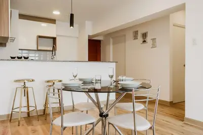 a dining room with a table and some chairs at Polished 2BR with Balcony in San Isidro in Lima