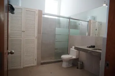 a bathroom with a toilet and a shower and a sink at MirandoelMar - Luna in Lima