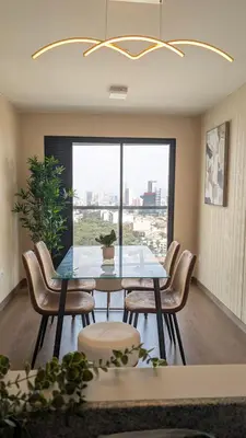 a dining room with a table and chairs and a window at Descanso en Oscuridad Absoluta in Lima