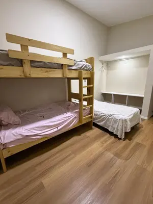two bunk beds in a room with wooden floors at Casa los Cipreses del Sol in Cieneguilla