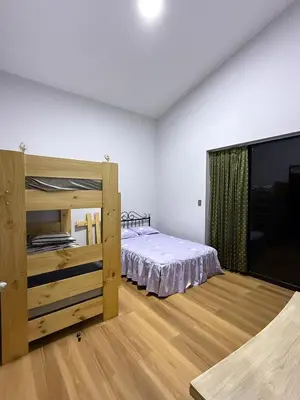 a room with a bed and a television in it at Casa los Cipreses del Sol in Cieneguilla