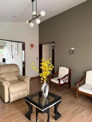 a living room with a couch and a table at Casa los Cipreses del Sol in Cieneguilla