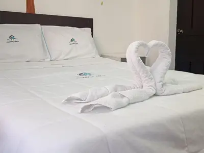 two swans made out of towels on a bed at Ccapaq Wasi II in Cusco