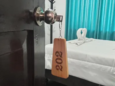 a room with a bed with a sign on it at Ccapaq Wasi II in Cusco
