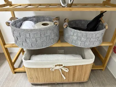 two baskets of towels and toilet paper on a shelf at Art10 Milu - Miraflores-Larcomar in Lima