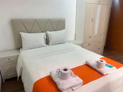 a bedroom with a bed with towels on it at Departamentos Sumaq Plaza II in Ayacucho