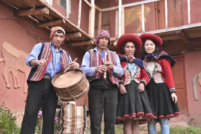 a group of people in traditional clothing standing next to a building at Casa de gumercindo in Coper