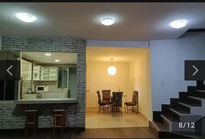 a living room with a staircase and a table and chairs at Casa En Asia in San Antonio