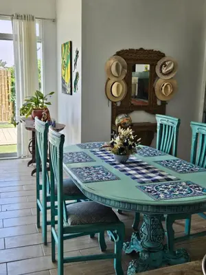 a dining room with a blue table and chairs at Beach Rooms Chincha in Tambo de Mora