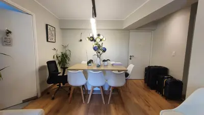 a dining room with a table and some white chairs at Beautiful and spacious apartment in San Felipe in Lima