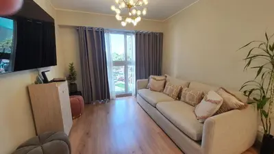 a living room with a couch and a large window at Beautiful and spacious apartment in San Felipe in Lima