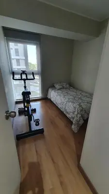 a small bedroom with a bed and a window at Beautiful and spacious apartment in San Felipe in Lima