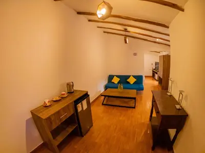 a living room with a blue couch and a table at Kay Pacha Wellness Place Eco in Ayacucho