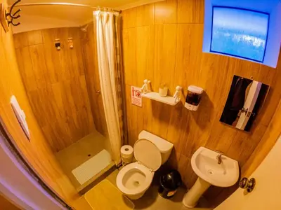 a small bathroom with a toilet and a sink at Kay Pacha Wellness Place Eco in Ayacucho