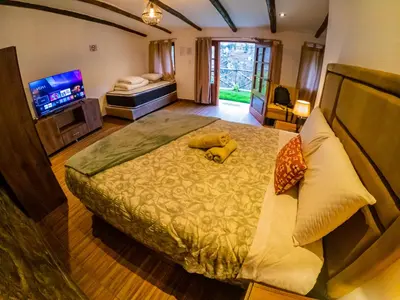a bedroom with a large bed with a stuffed animal on it at Kay Pacha Wellness Place Eco in Ayacucho