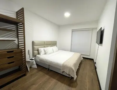 a bedroom with a bed and a television in it at 2 Bedroom Apartments San Isidro Business Zone in Lima