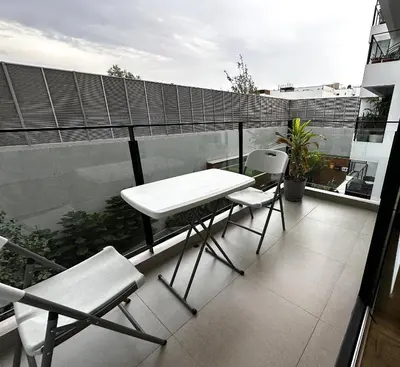 a white table and chairs on a balcony at 2 Bedroom Apartments San Isidro Business Zone in Lima