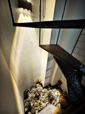 an overhead view of a stairs with flowers on the ground at Mini Apartamento BARRANCO in Lima