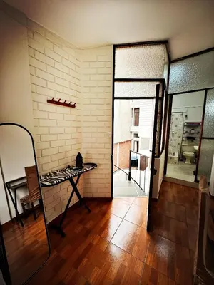 a room with a mirror and a table and a door at Mini Apartamento BARRANCO in Lima