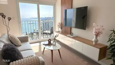a living room with a couch and a large window at Kaya - Luxury Stay - 1BR - Sea View - Private Balcony in Lima