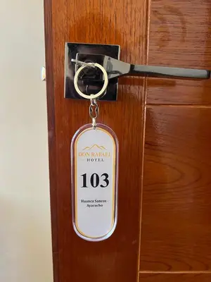 a key tag is attached to a wooden door at Don Rafael - Hotel