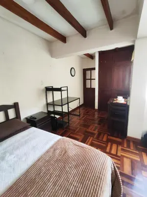 a bedroom with a bed and a wooden floor at Amplia habitación independiente Larcomar in Lima