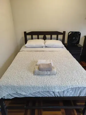 a bed with a towel on top of it at Amplia habitación independiente Larcomar in Lima